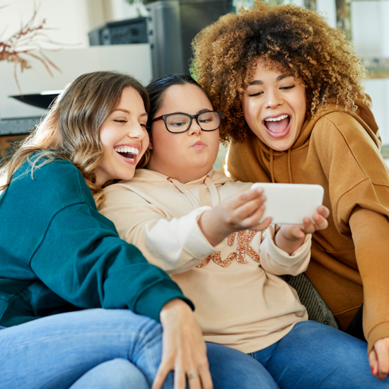 Three females posing for a selfie smiling