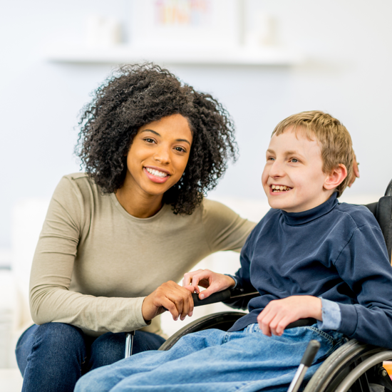 Female caregiver with a young male in a wheelchair