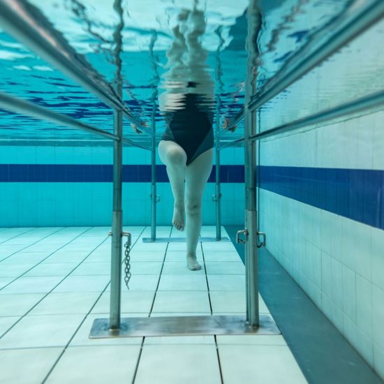 Female doing hydrotherapy in a swimming pool
